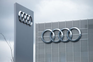 photograph of Audi logo on the outside of grey building