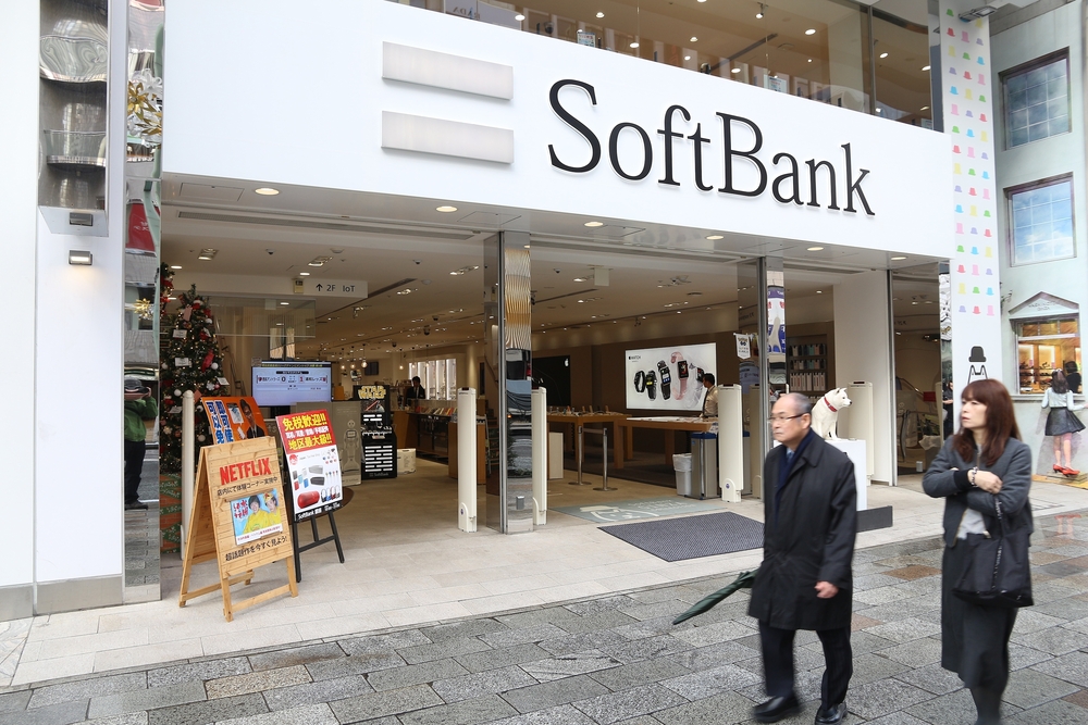 a photo of a SoftBank building entrance—owned by SoftBank CEO Masayoshi Son —with people walking outside it