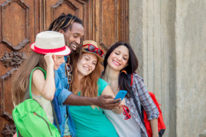 Four people with a phone.