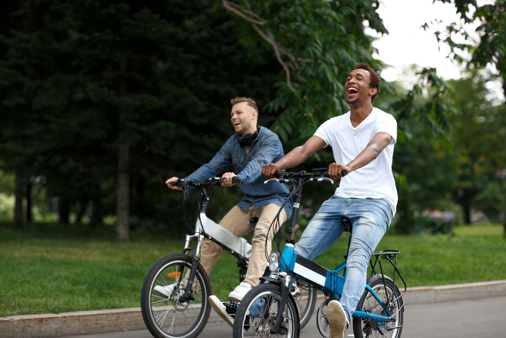 Two men on electric powered bicycles