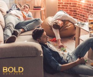 Guys having hangover in a room after a party.