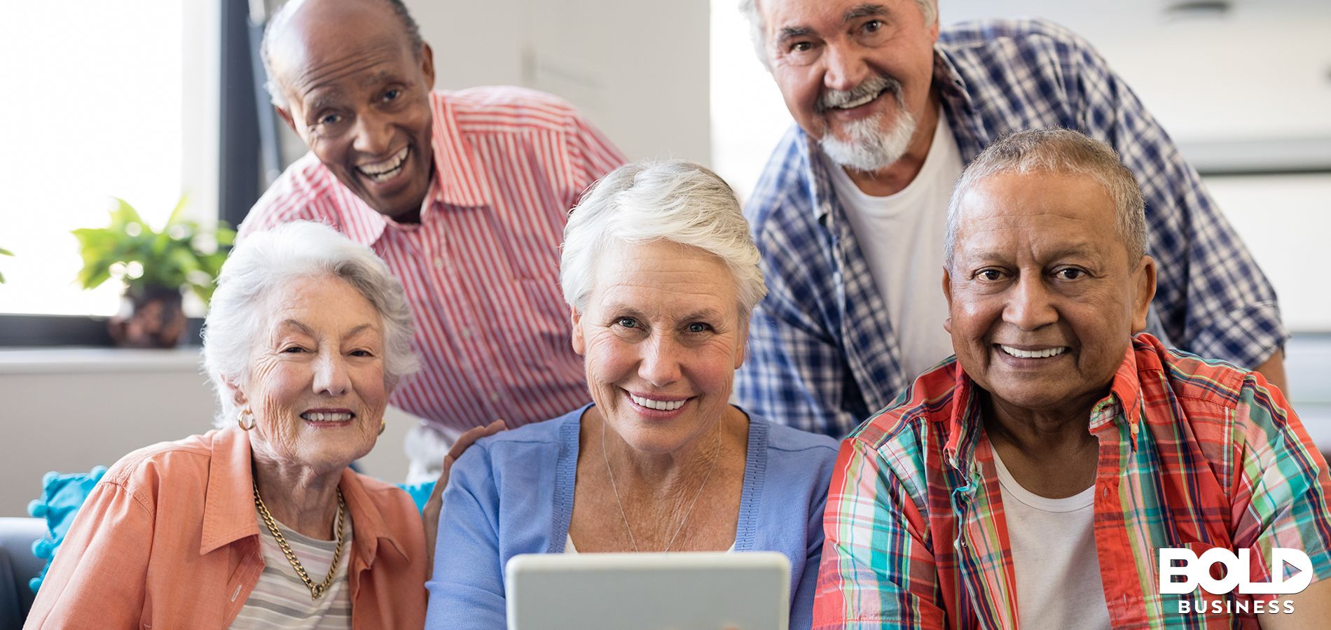 a photo of a group of seniors looking at a tablet that has their health records stored by StoriiCare