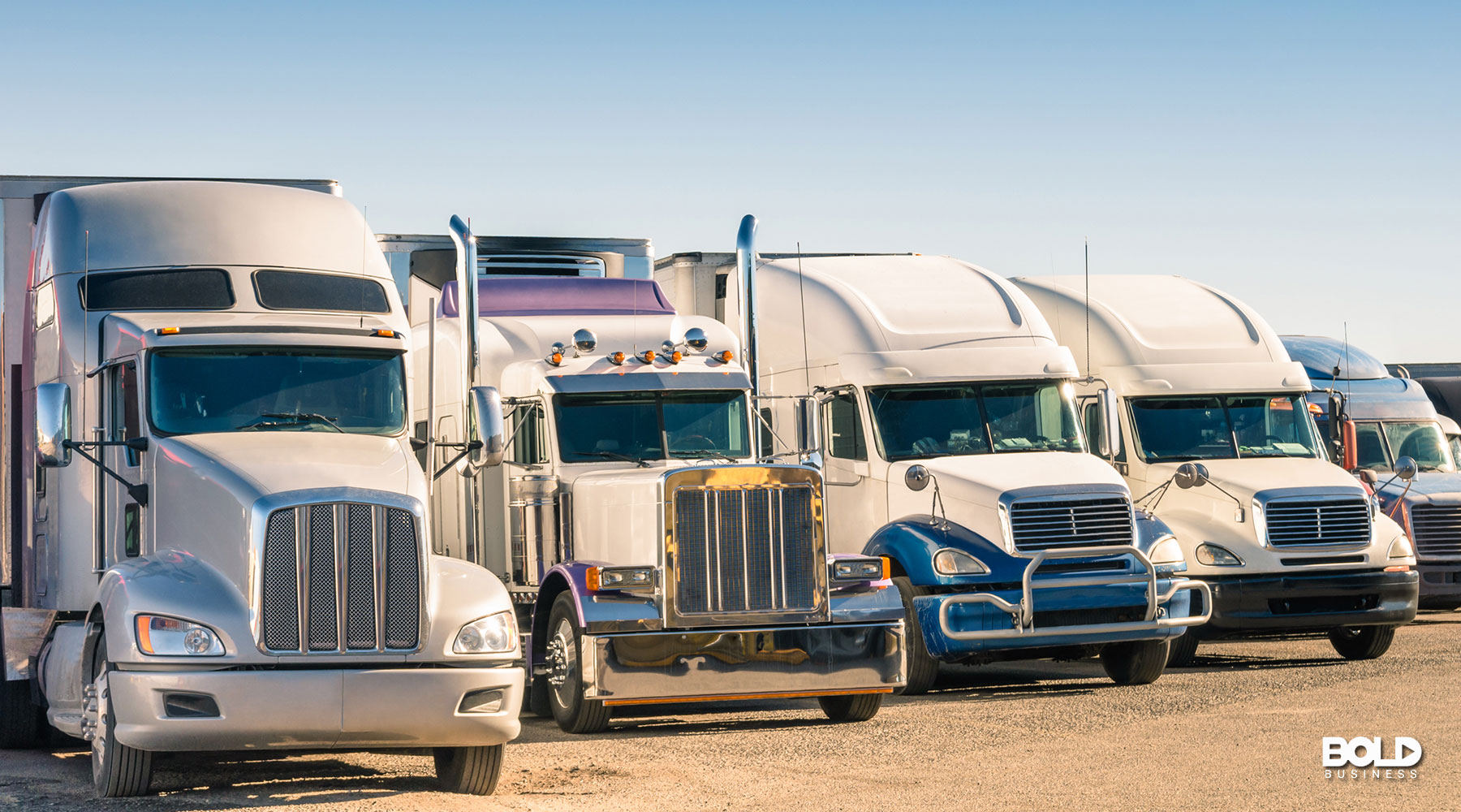 A line of semi trucks on the road
