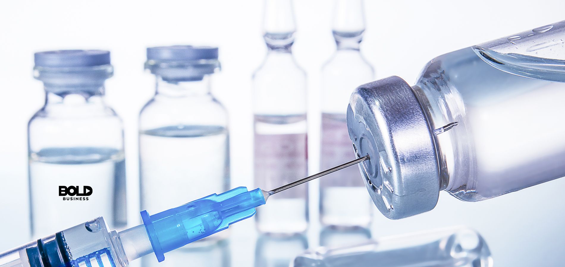 syringe and a vial of vaccine