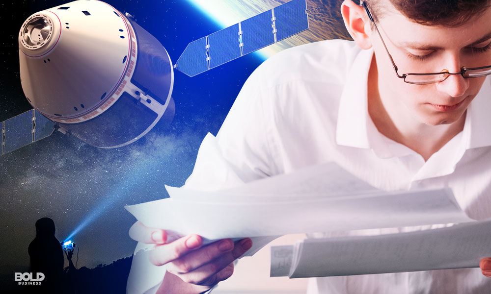 spacecraft and man in white shirt in foreground reading from notes looking at fossil fuel numbers