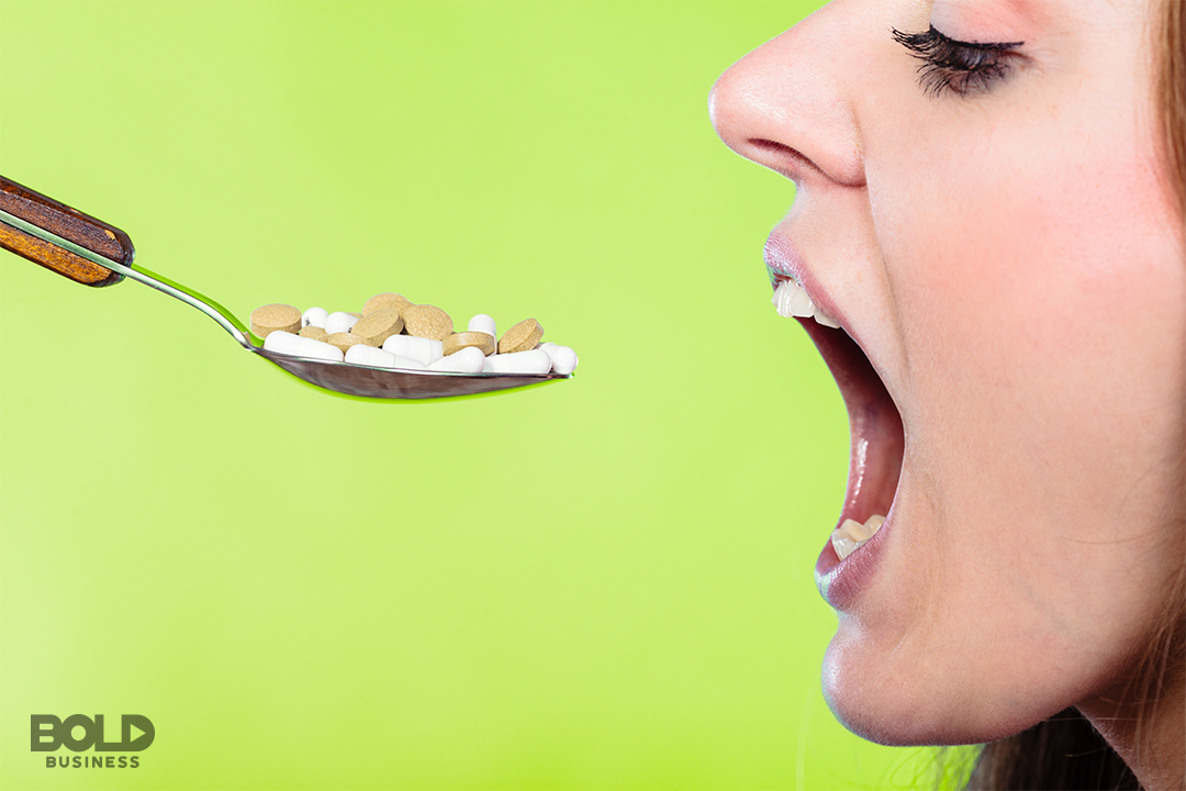 diet based on genetics, woman about to put a spoonful of pills in her mouth