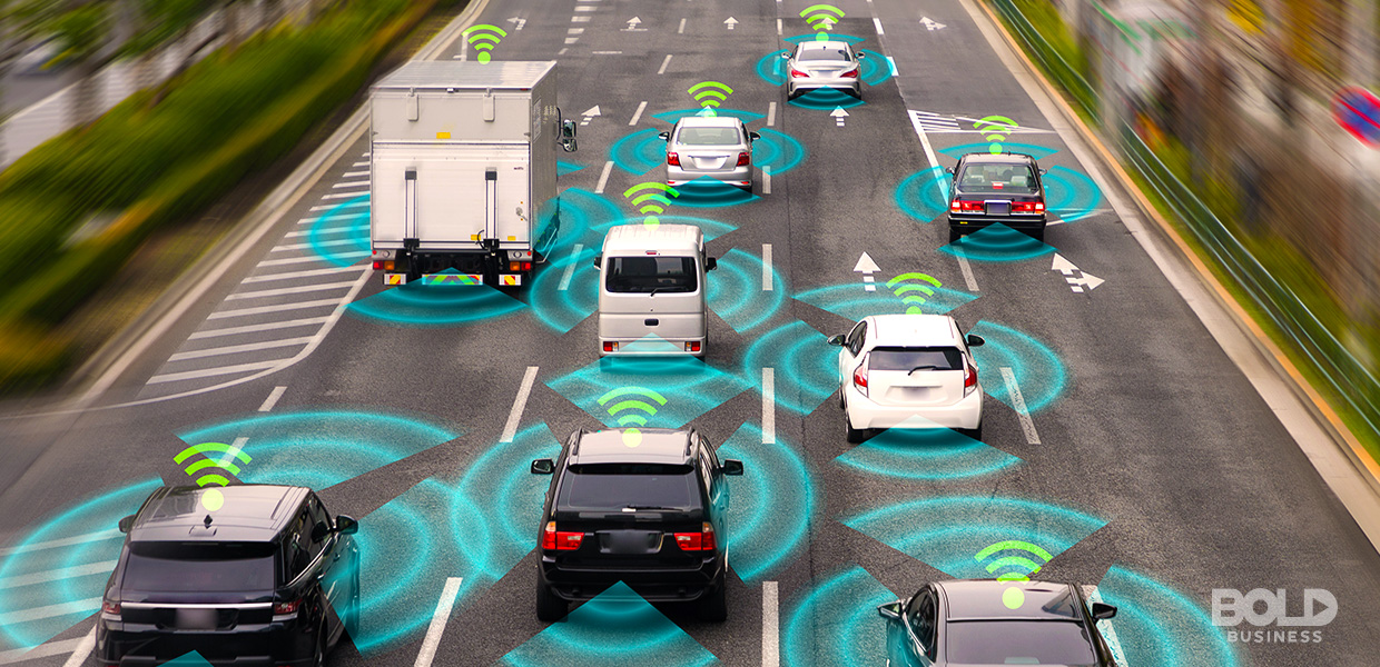 a photo of different vehicles on a highway road producing waves of signals while there are current innovations in transport systems like V2X technology