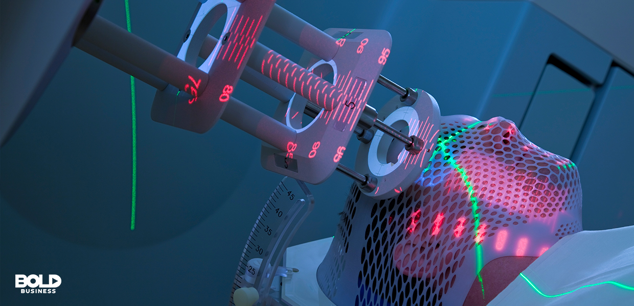 a photo of a radio frequency therapy device pointed to a tumor found in the brain of a patient who is lying down and undergoing new cancer treatment care