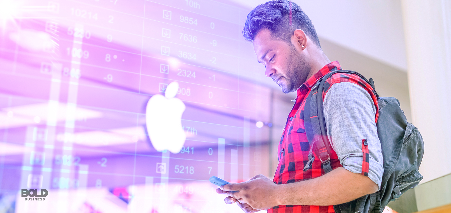 a photo of a man looking down at his phone while standing outside a building with an Apple logo shown visibly at the center, thus depicting discussions on the hot topic of Apple apps and the Apple App Store