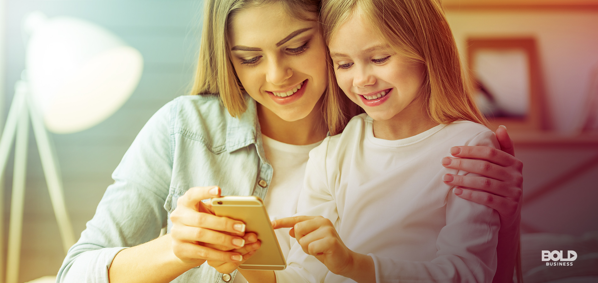 a photo of a young mother with her middle-school aged daughter looking at a smartphone that has several good apps for kids and best apps for kids installed in it