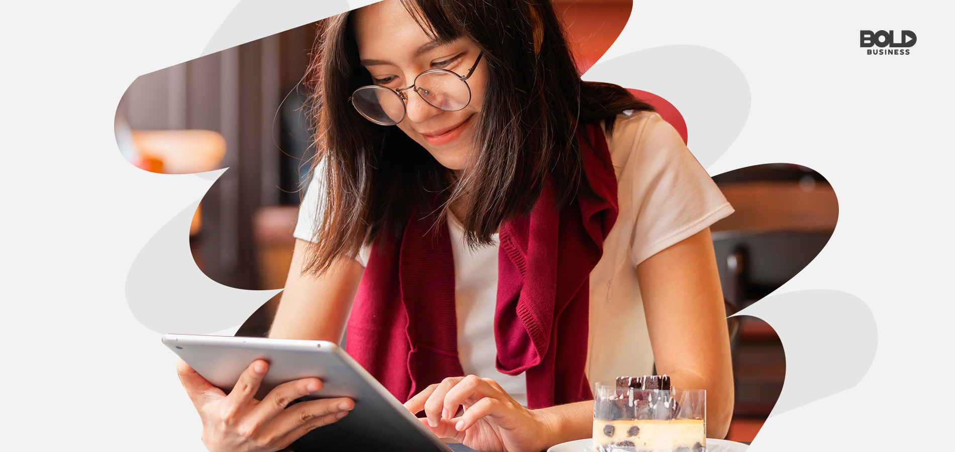 a photo of a young woman wearing glasses reading Wattpad Stories on her smart tablet