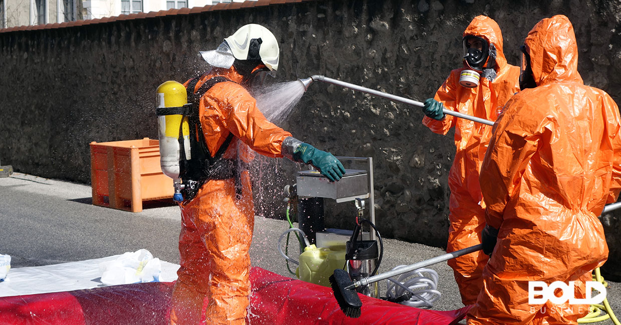Some dudes in hazmat suits spraying off another dude