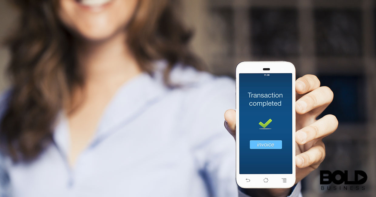 A woman using a touch-free transaction to buy stuff