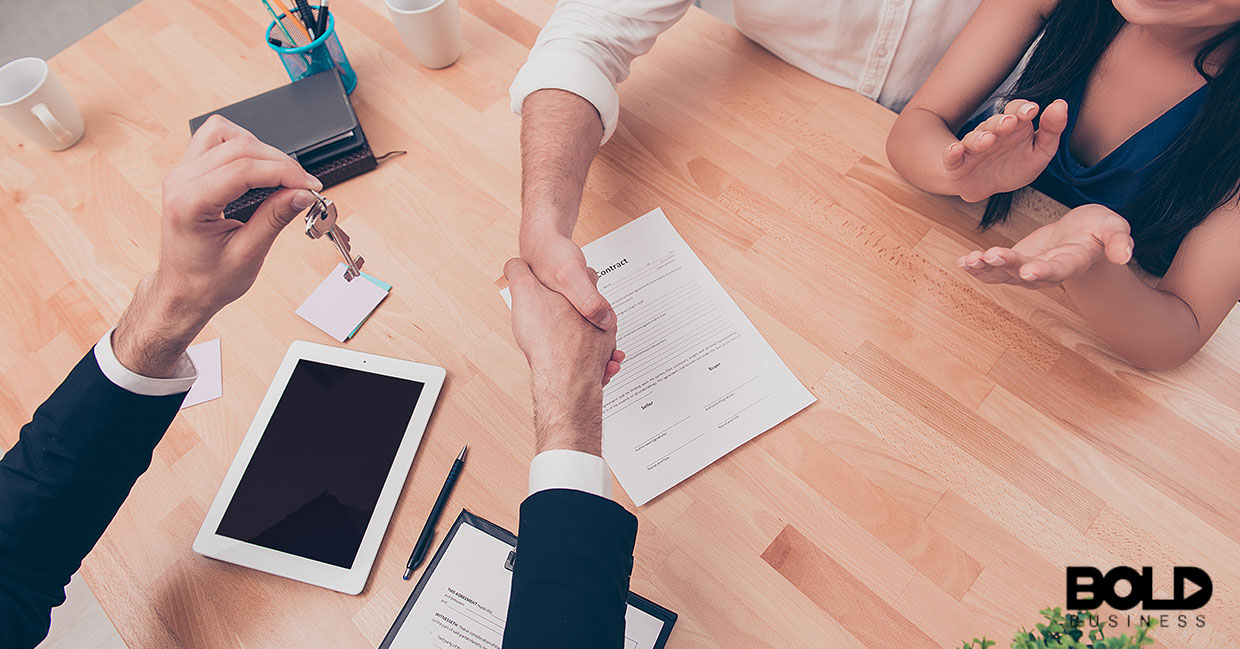 A real estate agent shaking a buyer's hand