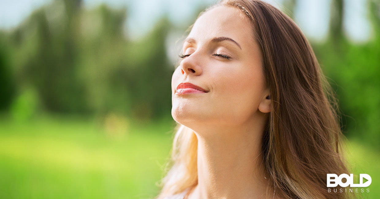 A woman taking a deep breath of fresh air