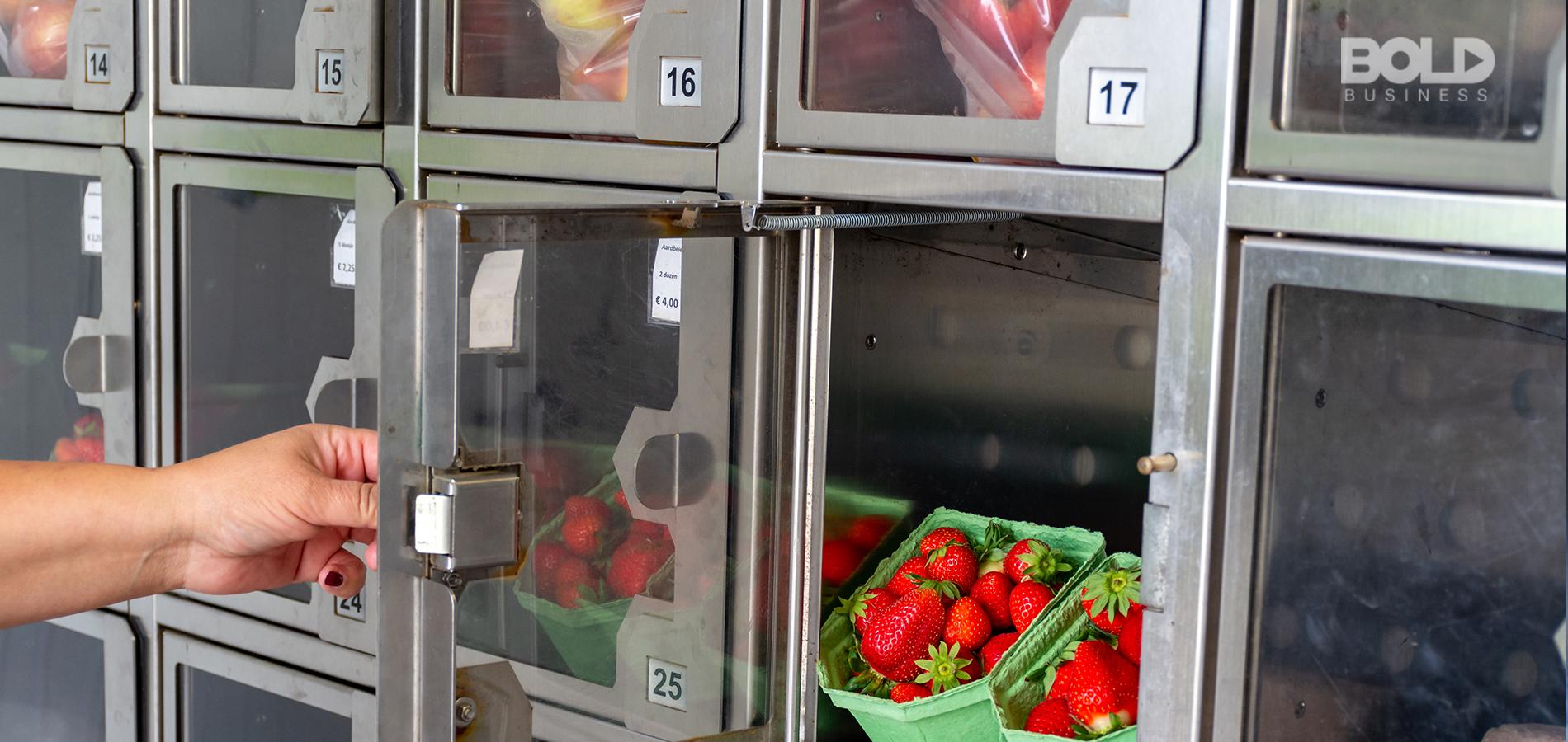 Someone getting some fruit from an automat