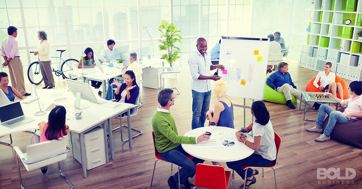 A bunch of people working in a big open space