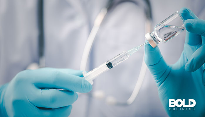 A medical professional about to administer a monoclonal antibody shot