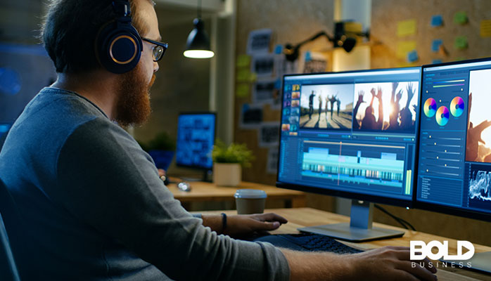 A dude with headphones on editing a video