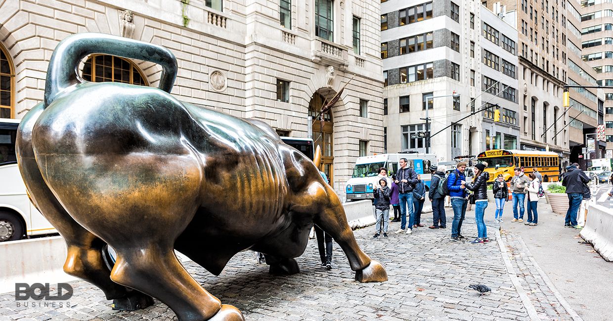 A group of people about to be gored by a rampaging bull