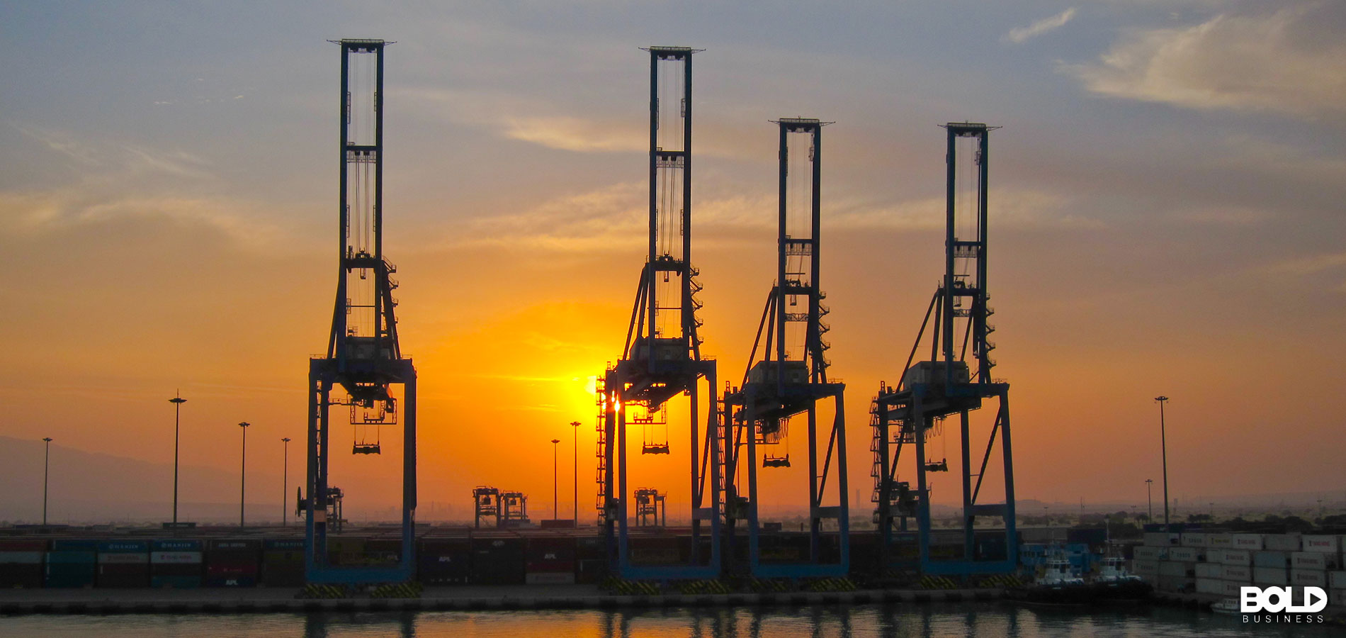 A bunch of cranes at a port