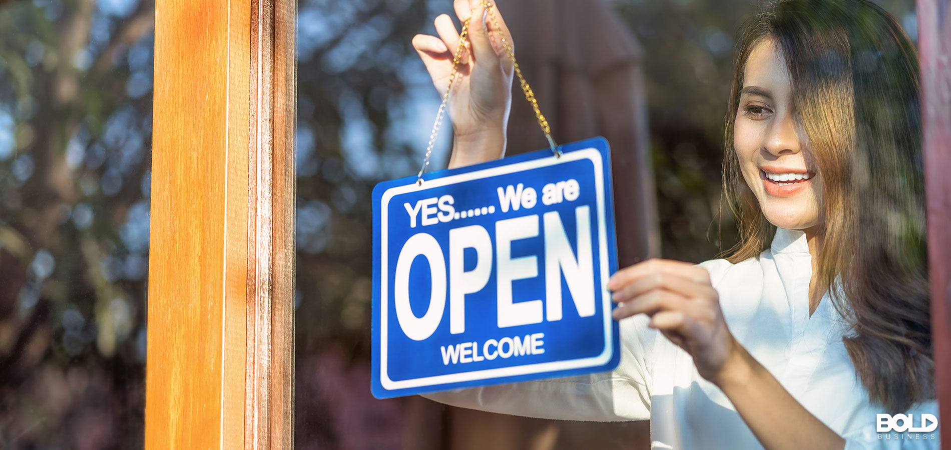 A woman opening up her shop for business