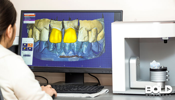 A dental technician looking at some teeth