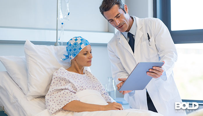 A doctor showing a cancer patient his artwork