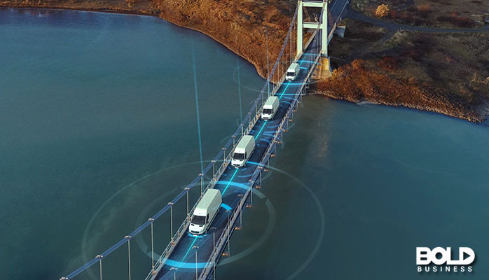 A bunch of trucks driving over a bridge