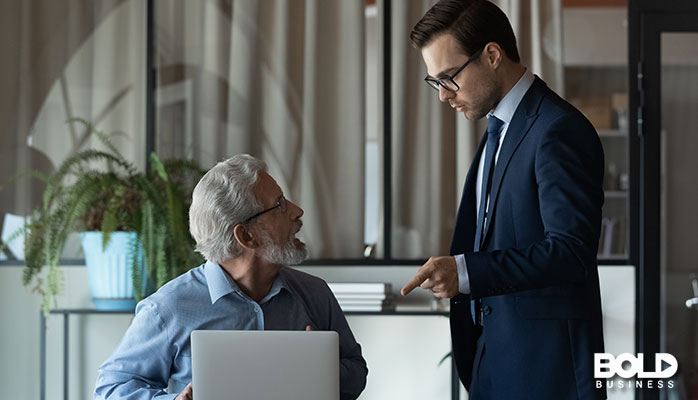 A younger boss giving his older worker some trouble