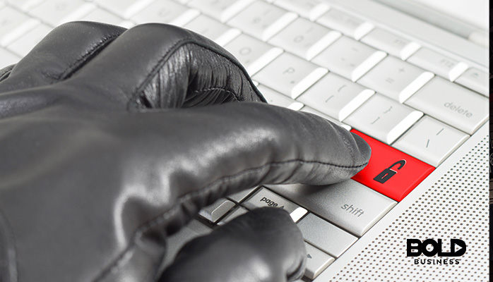 A gloved hand using a colorful keyboard