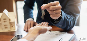 Some dudes exchanging a key for the sake of office conversion