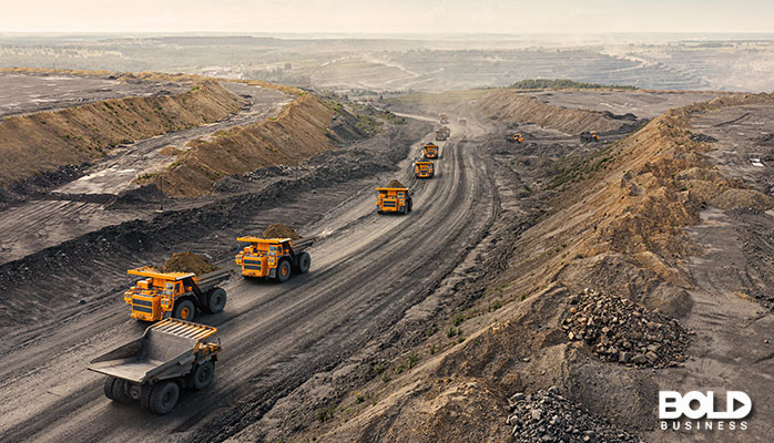some trucks and machine riding the mining road