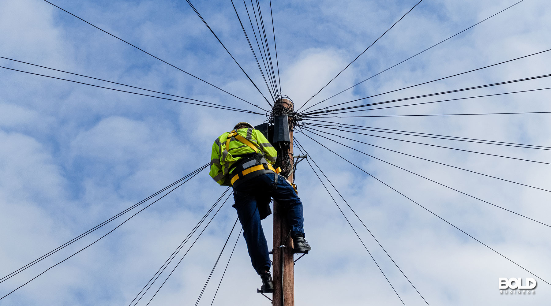 a dude doing some broadband expansion on a pole