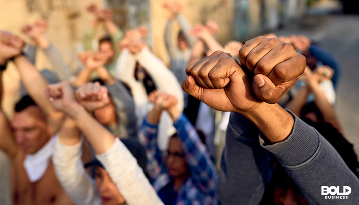 a bunch of fists in the air in solidarity