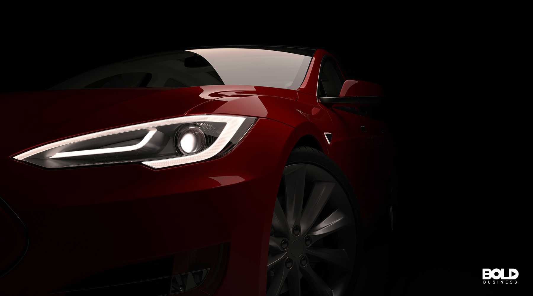 a Tesla car sitting in the dark