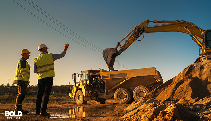 some dudes overseeing a big mining operation