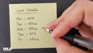 someone using a post it for hybrid workforce best practices