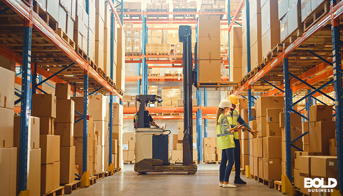 some people working with a robot in a warehouse